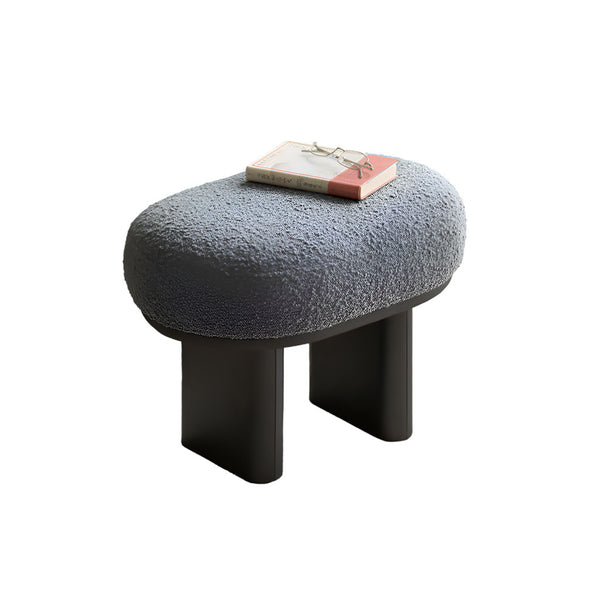 Stylish bouclé stool with oval seating and sturdy metal legs. Contemporary furniture.